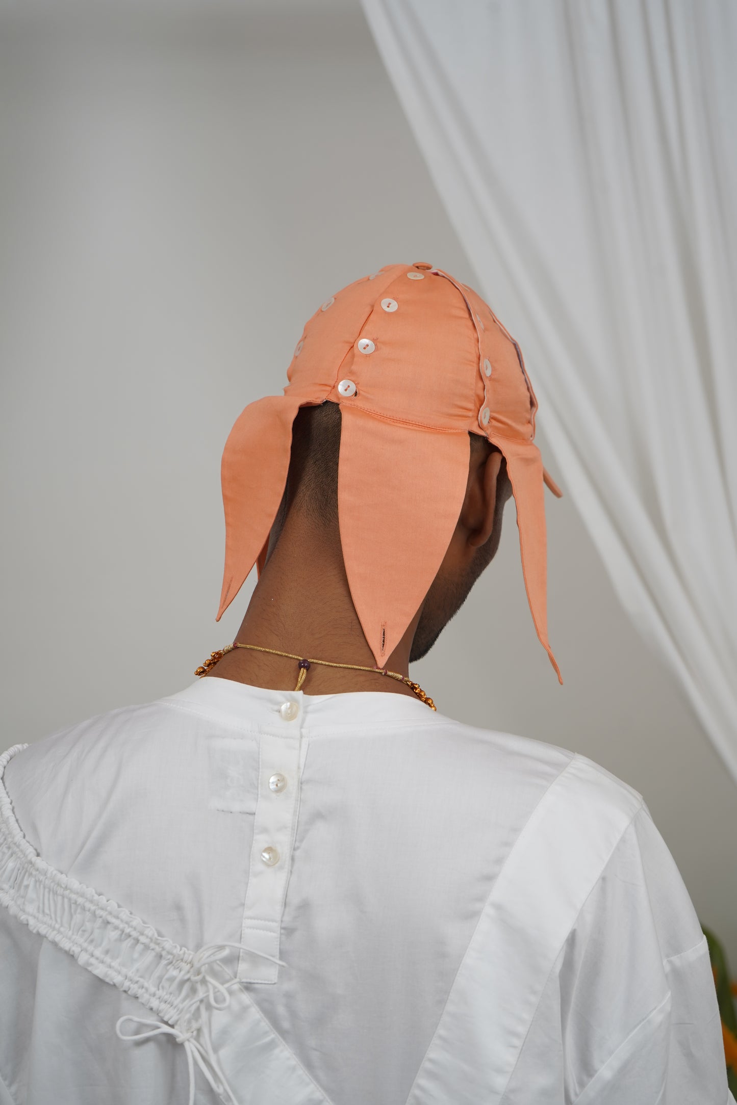 Deconstructable buttoned placket panel cap