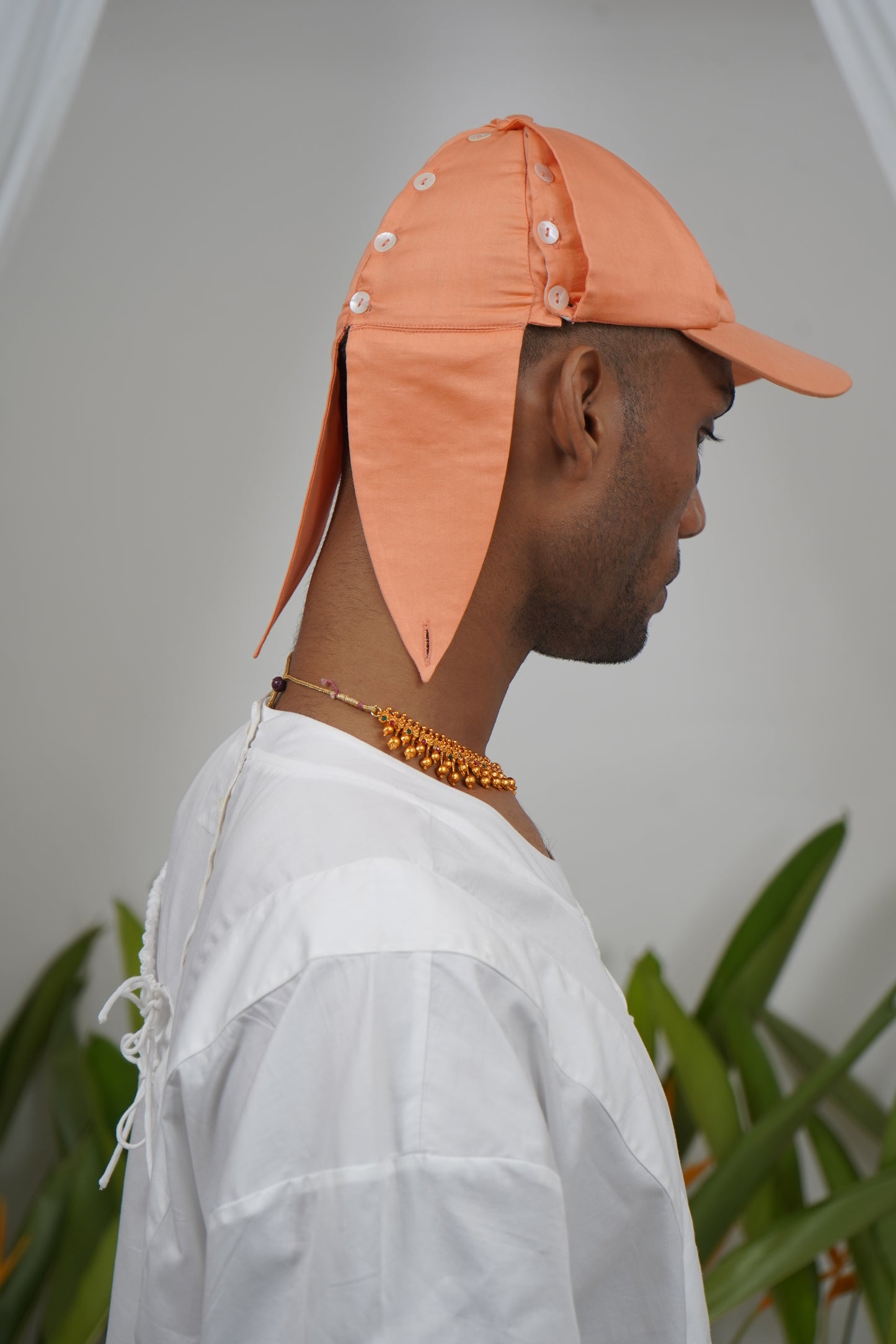 Deconstructable buttoned placket panel cap